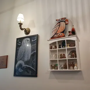 a shelf of owl figurines