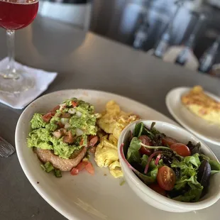 Avocado toast with hash-brown casserole and hibiscus and grapefruit mimosa on the side