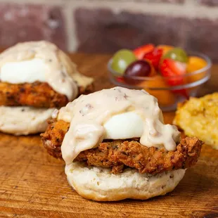 two fried chicken sandwiches on a wooden cutting board