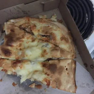 What was left to eat of the calzone after finding where the chicken was. Notice it's flat like a pizza obviously not a calzone