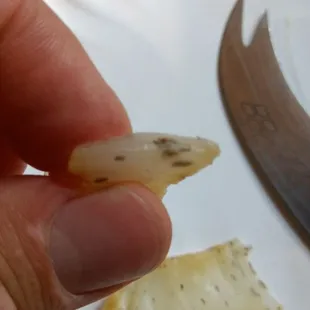 a person holding a piece of food