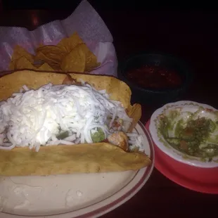 Huge Acalpulco taco salad with grilled steak, shrimp, chicken, guacamole, sour cream and black beans.