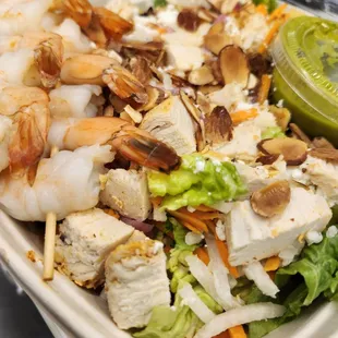 a salad with shrimp and lettuce