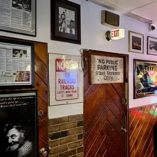 the entrance to a bar with posters on the wall