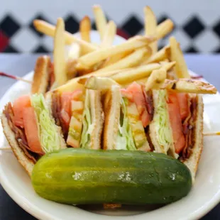 a plate of sandwiches and french fries