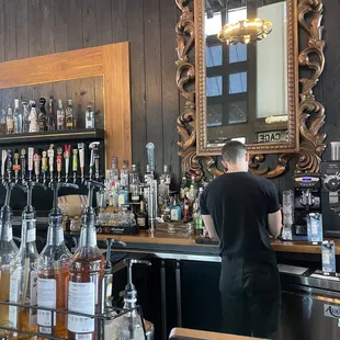 a man behind the bar at a restaurant