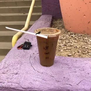a coffee cup with a straw in it