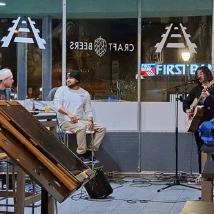 Seth Kaminsky performing with hosts CJ Washington and Devin Wright nearby