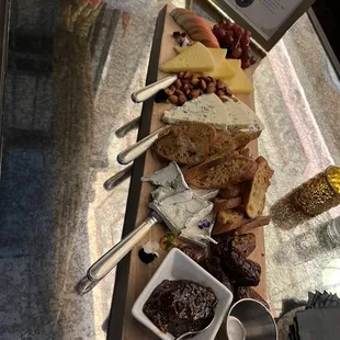 Charcuterie. Various cheese, almonds apples, grapes and dates.