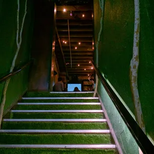 Coming up the stairs.