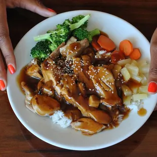 a person holding a plate of food