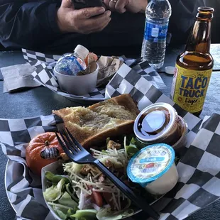 a plate of food and a bottle of beer