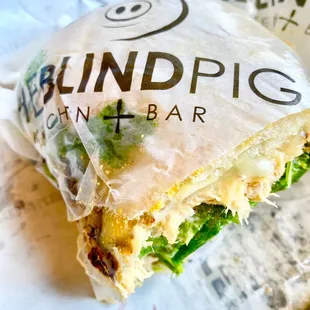 a sandwich wrapped in plastic wrap