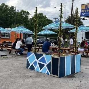 a group of people sitting at picnic tables