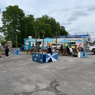 a group of people sitting at picnic tables