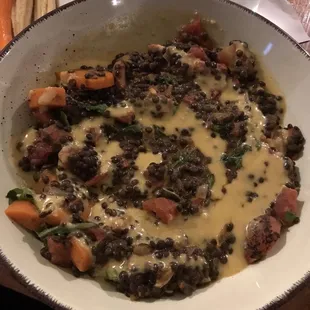 Curried lentils over roasted smashed sweet potatoes, lemon tahini dressing - vegan and delicious