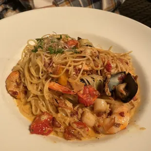 a plate of pasta with seafood