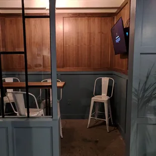 One of the small rooms off to the side with table and TV