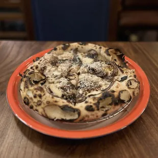 Truffle pizza made with shaved bella and portabella mushrooms and mozarella, all on the sourdough pizza dough.