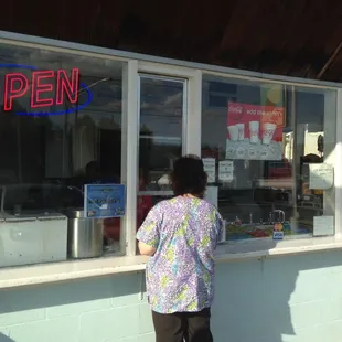a woman standing in front of a store
