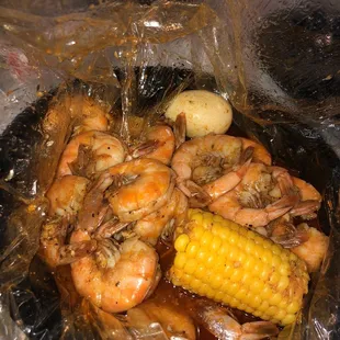 a corn on the cob and potatoes