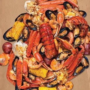 a pile of crab legs, corn, potatoes, and corn on the cob