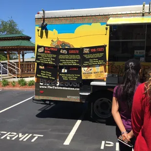 two people standing in front of the truck