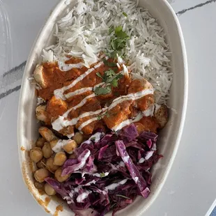 a bowl of rice, meat, and vegetables