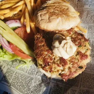Crab cake sandwich served with French Fries.