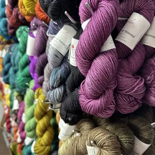Photo of colorful, luxurious hand dyed yarn on display in the shop. This particular yarn is from Anzula in Fresno.