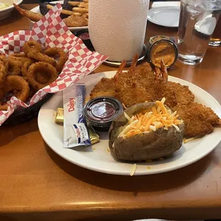Onion rings, butterfly shrimp, baked potato