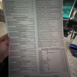 a person holding a menu
