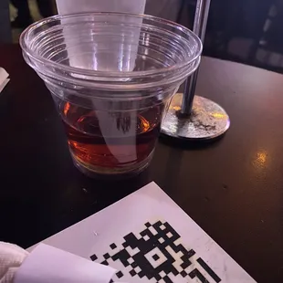 a drink in a plastic cup on a table