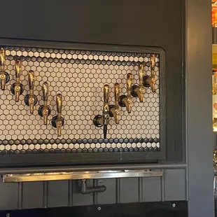 a wall mounted beer tap in a bar