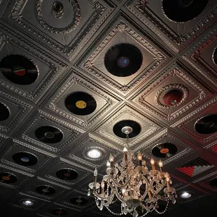 a chandelier with vinyl records on the ceiling