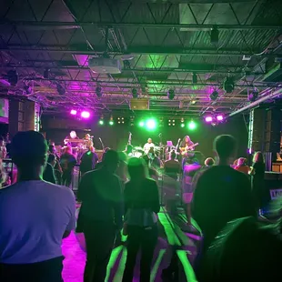 a group of people dancing in a dark room