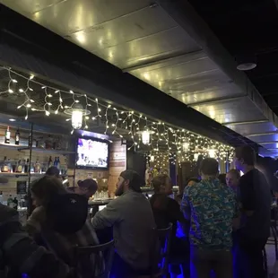 a group of people sitting at a bar