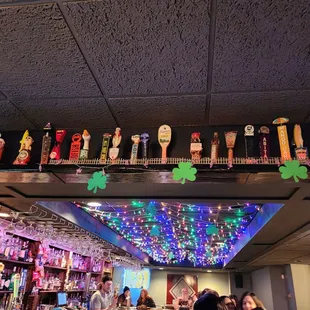 a row of beer taps on the ceiling