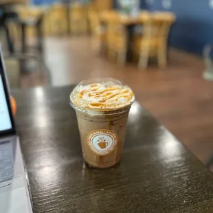 a cup of coffee and a laptop on a table