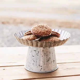a cookie in a tin on a wooden table