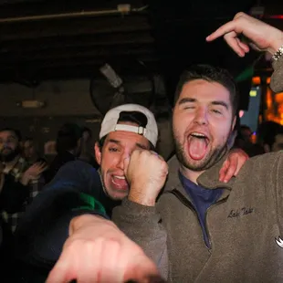 two men with their fists in the air