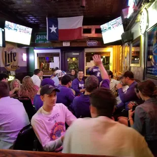 a large group of people sitting at a bar