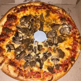 Small mushroom and meatball pizza