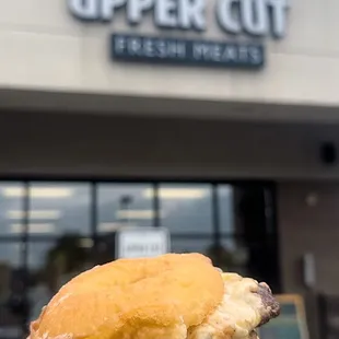 a hand holding a hamburger