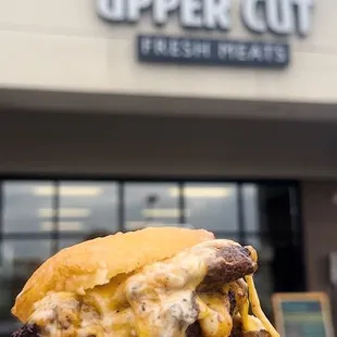 a person holding a sandwich