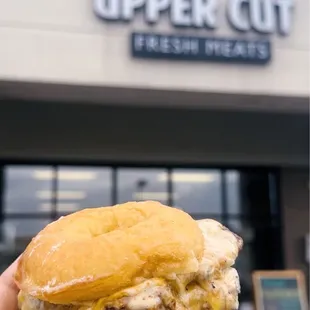 a hand holding a sandwich