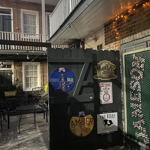 a black refrigerator with stickers on it