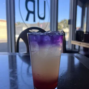 a purple and red drink on a table