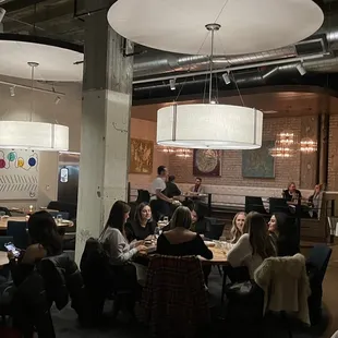 a group of people sitting at tables in a restaurant