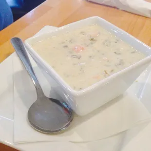 a bowl of soup on a plate with a spoon